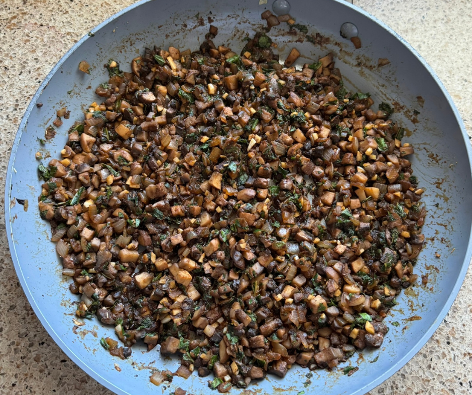 Finely chopped mushrooms, onions, and kale cooked together in a skillet for homemade veggie burgers. Finely chopped mushrooms, onions, and kale cooked together in a skillet for homemade veggie burgers.