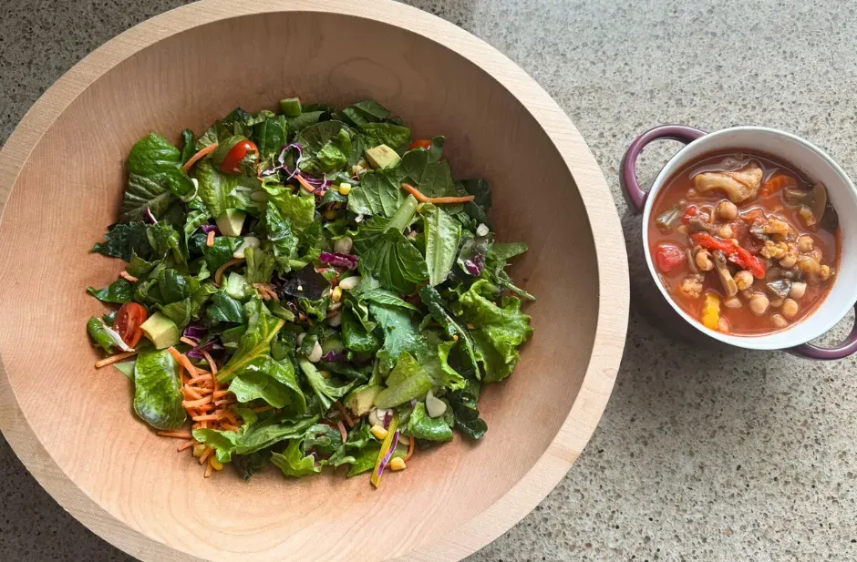 Flexible freezer vegetable soup served beside a dressed Sweet Corn Salad of the Week bowl on a kitchen counter