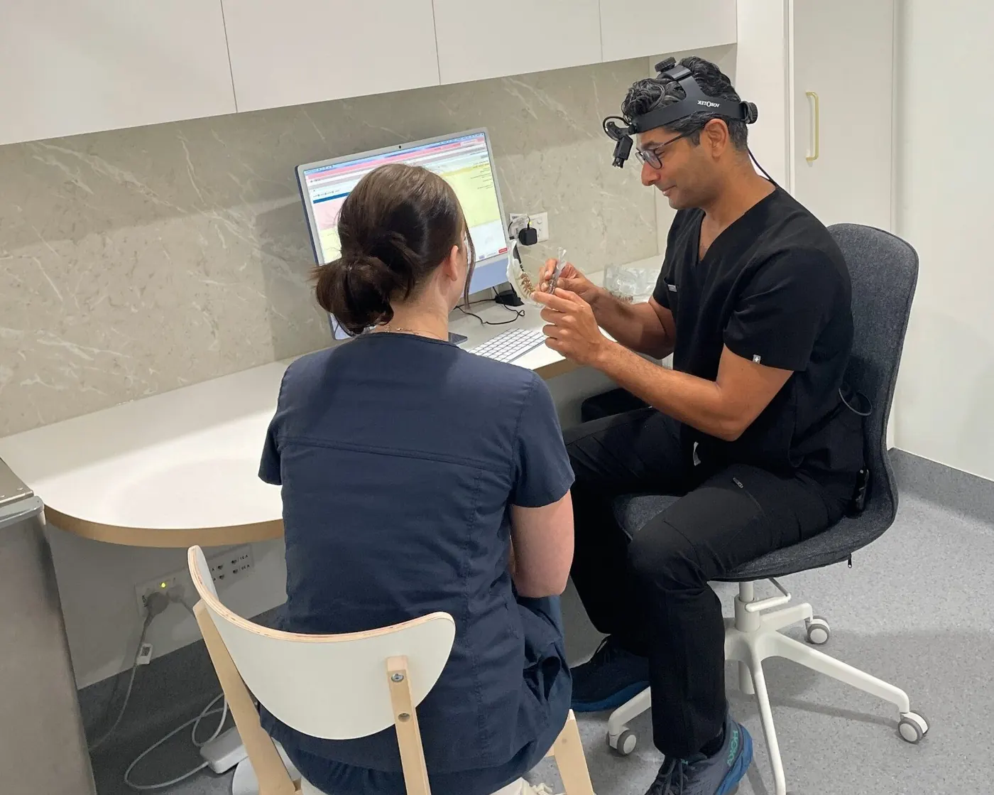 A Focus specialist and team member reviewing a case at the clinic