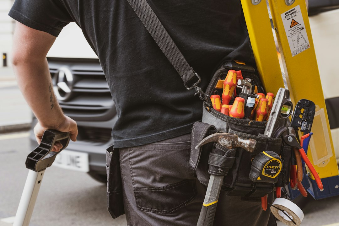 Electrician carrying tools back to the van