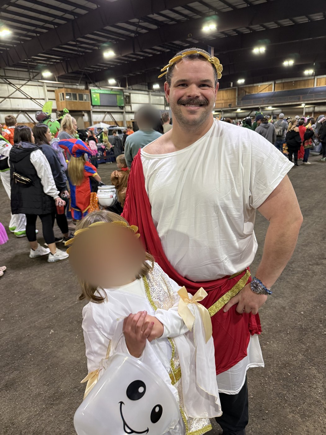 Girl in a Greek goddess costume with a man in a white and red toga