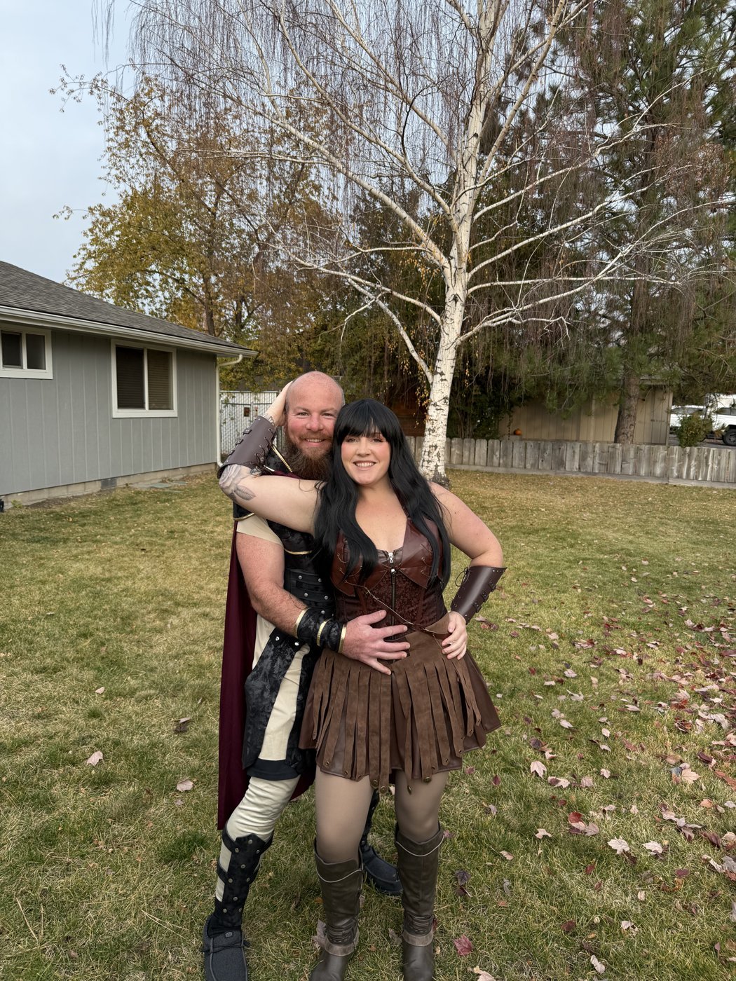 Couple dressed as Hercules and Xena in the backyard
