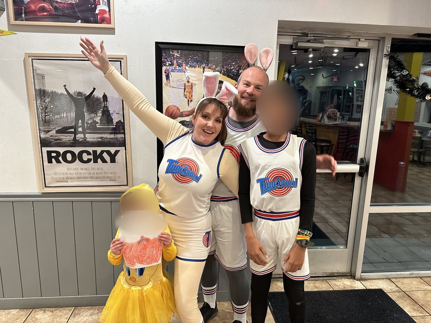 Family in Tune Squad jerseys and a Tweety costume