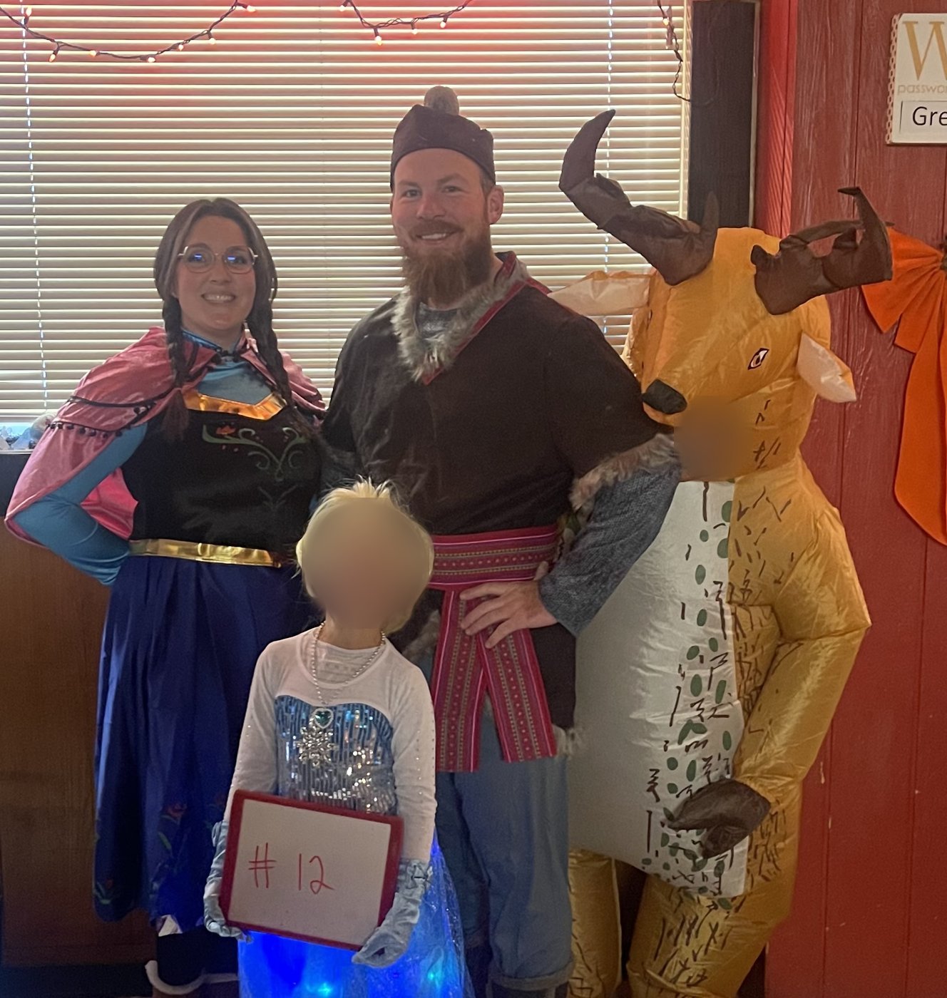 Family dressed as Anna, Kristoff, Elsa and Sven from Frozen
