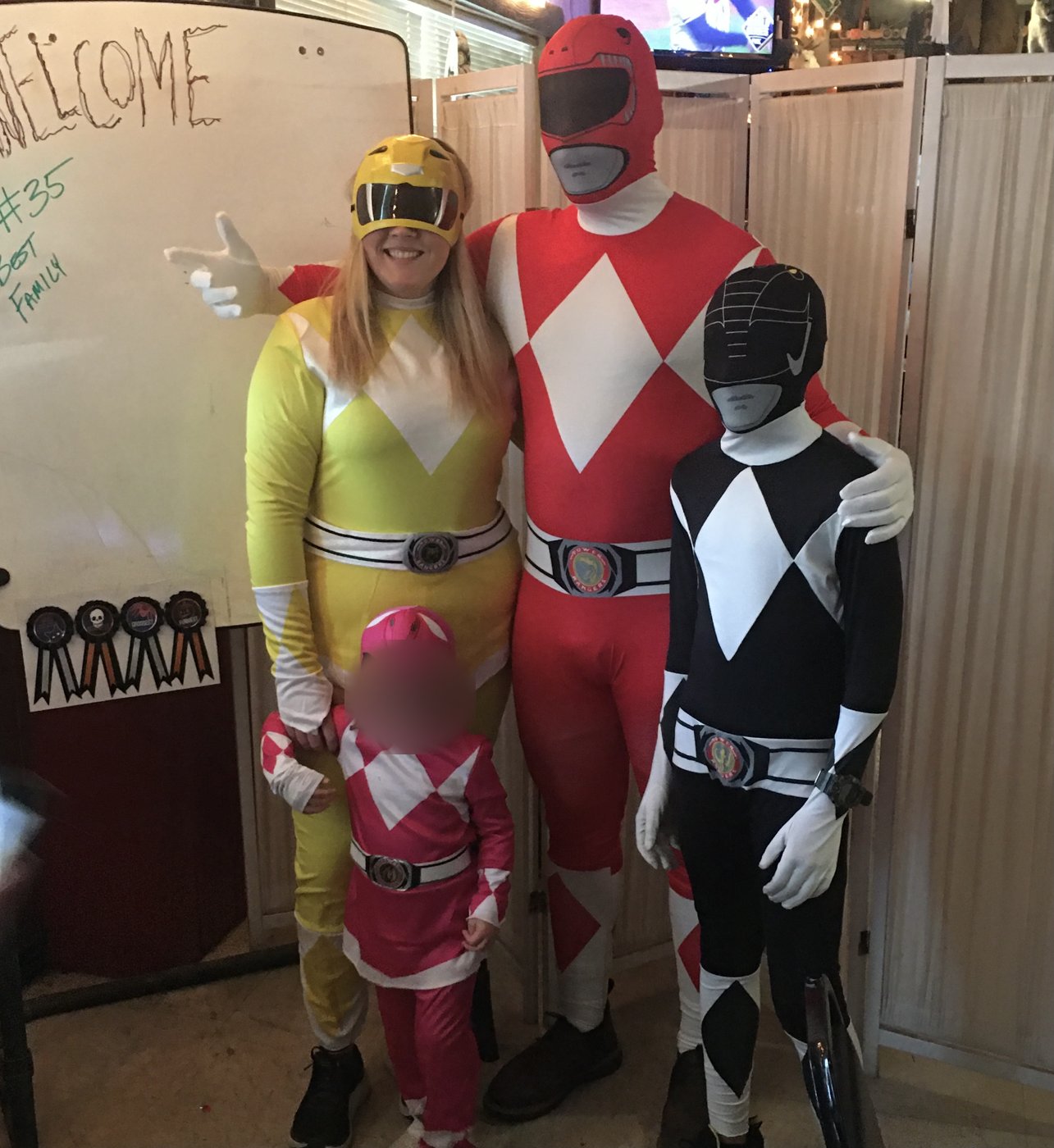 Family dressed as the Yellow, Red, Black and Pink Power Rangers