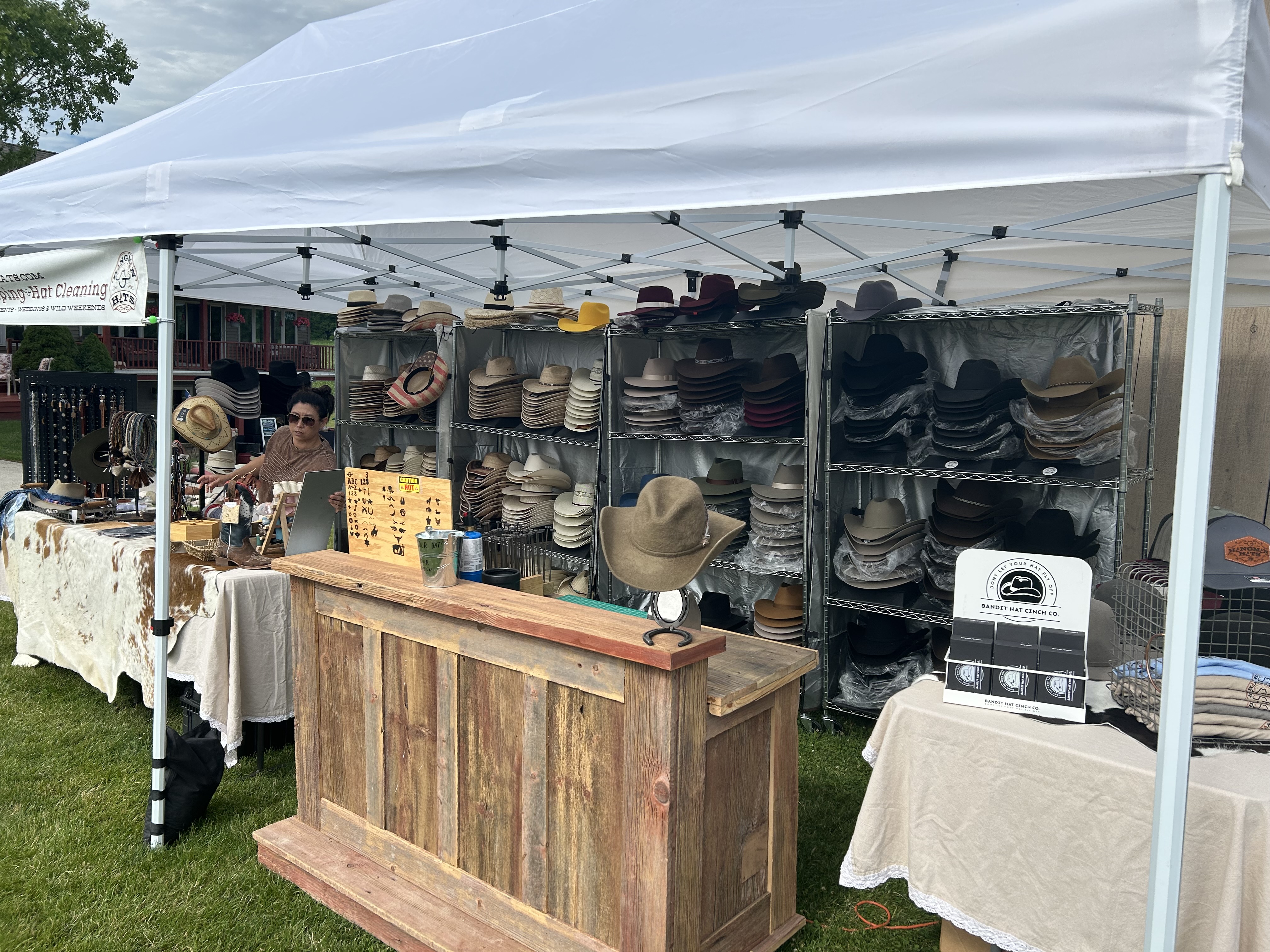 Hangman Hats hat bar setup with racks of hats and a wooden bar counter