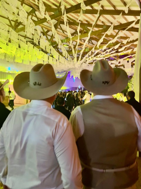 Two guests wearing hats at a private event