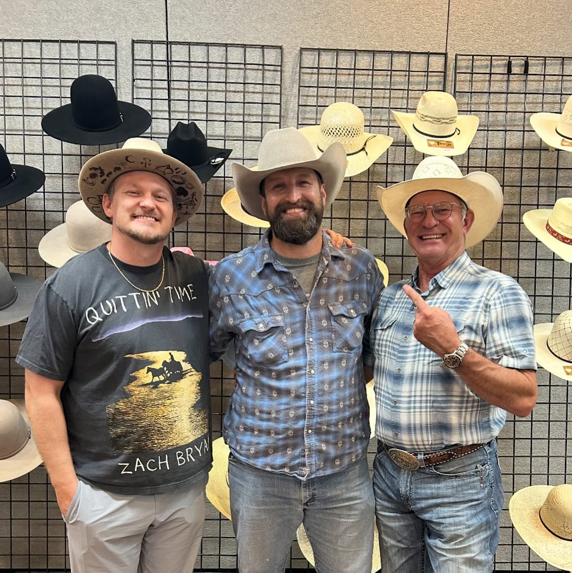 The owner of Hangman Hats surrounded by hat racks during the hat shaping course
