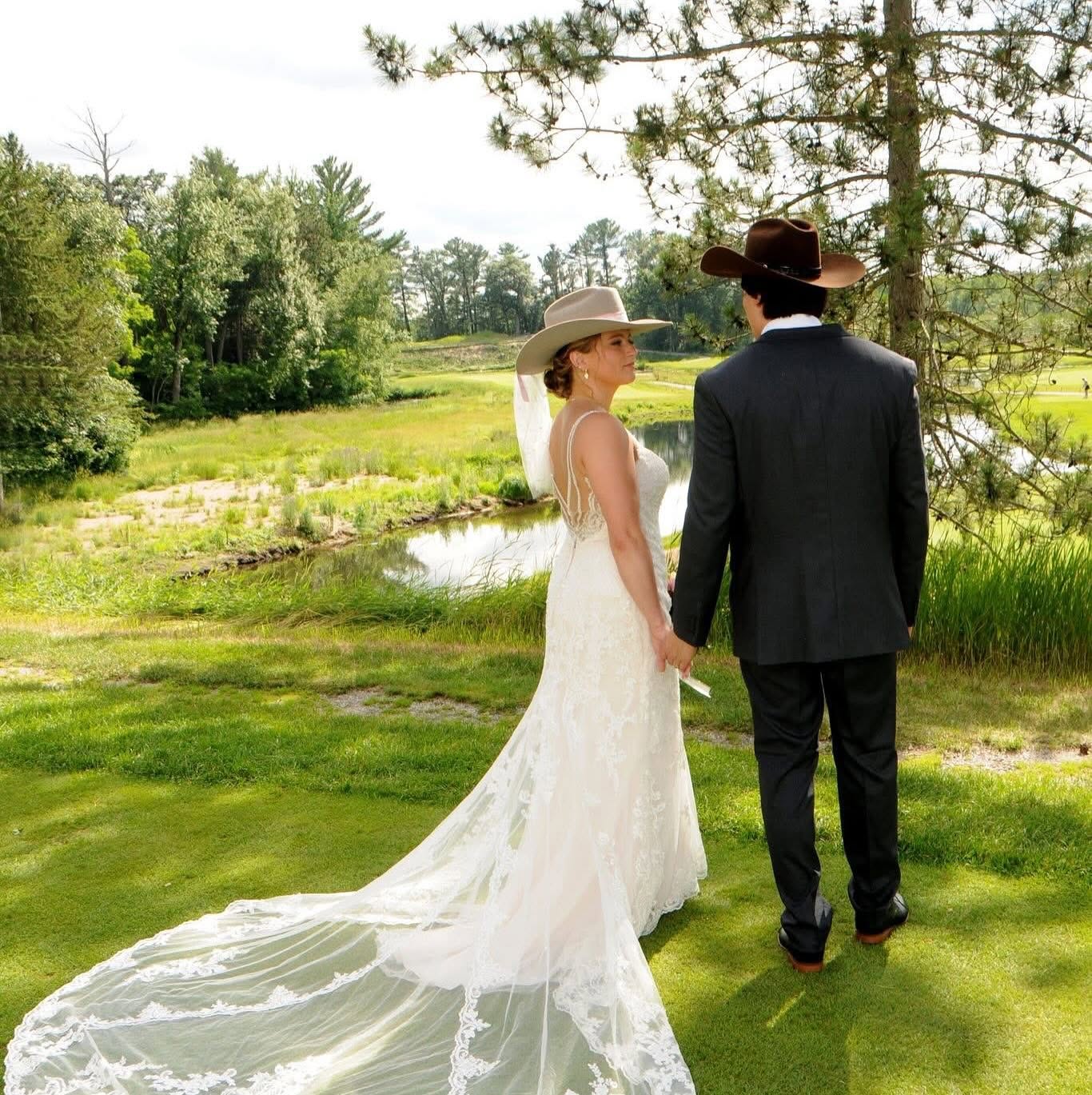 Bride and groom both wearing custom Hangman Hats