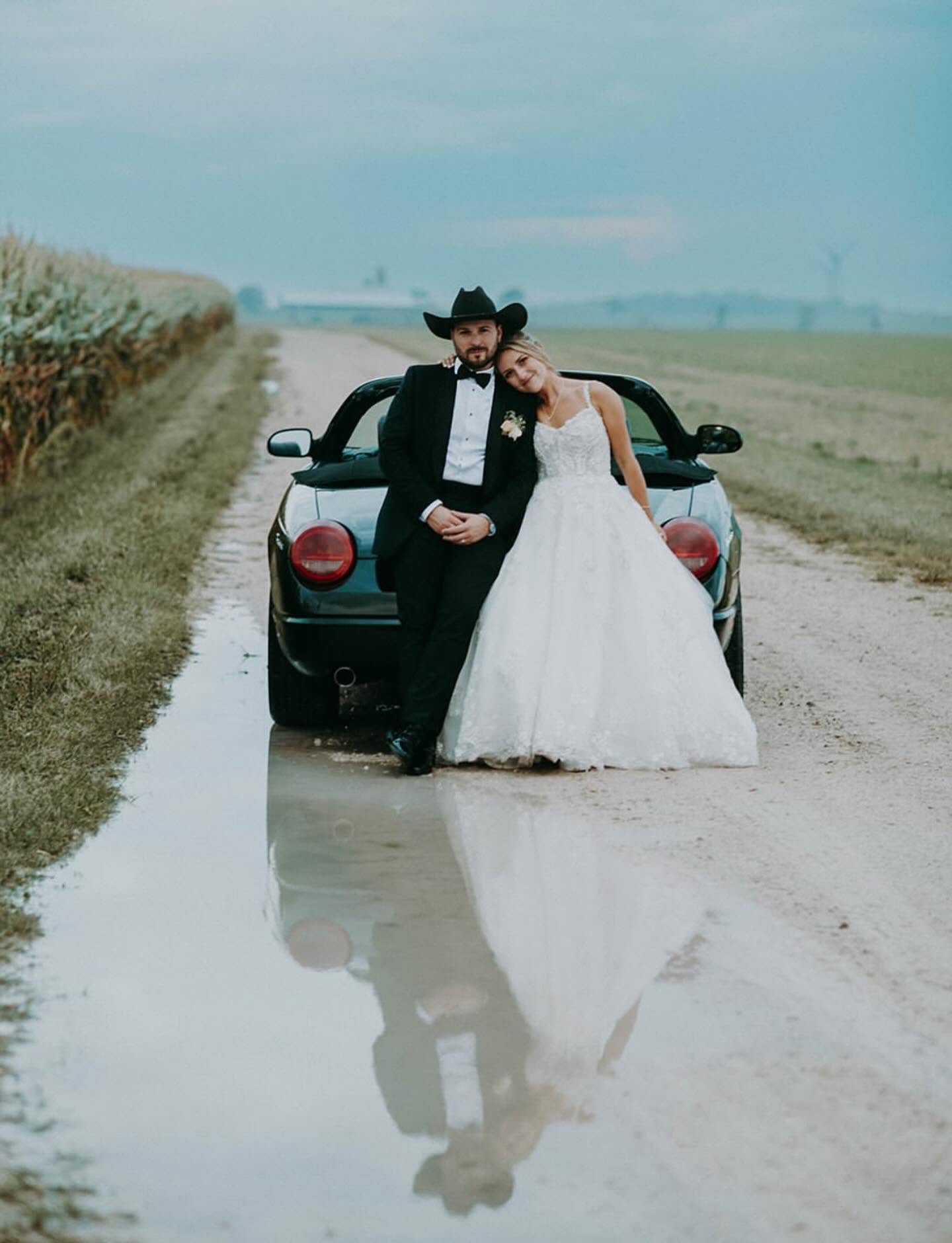 Bride and groom in front of a vintage truck