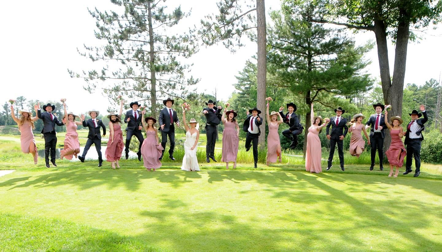 Wedding party celebrating in cowboy hats