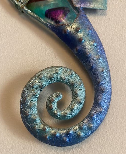 A blue coloured metal seahorse ornament