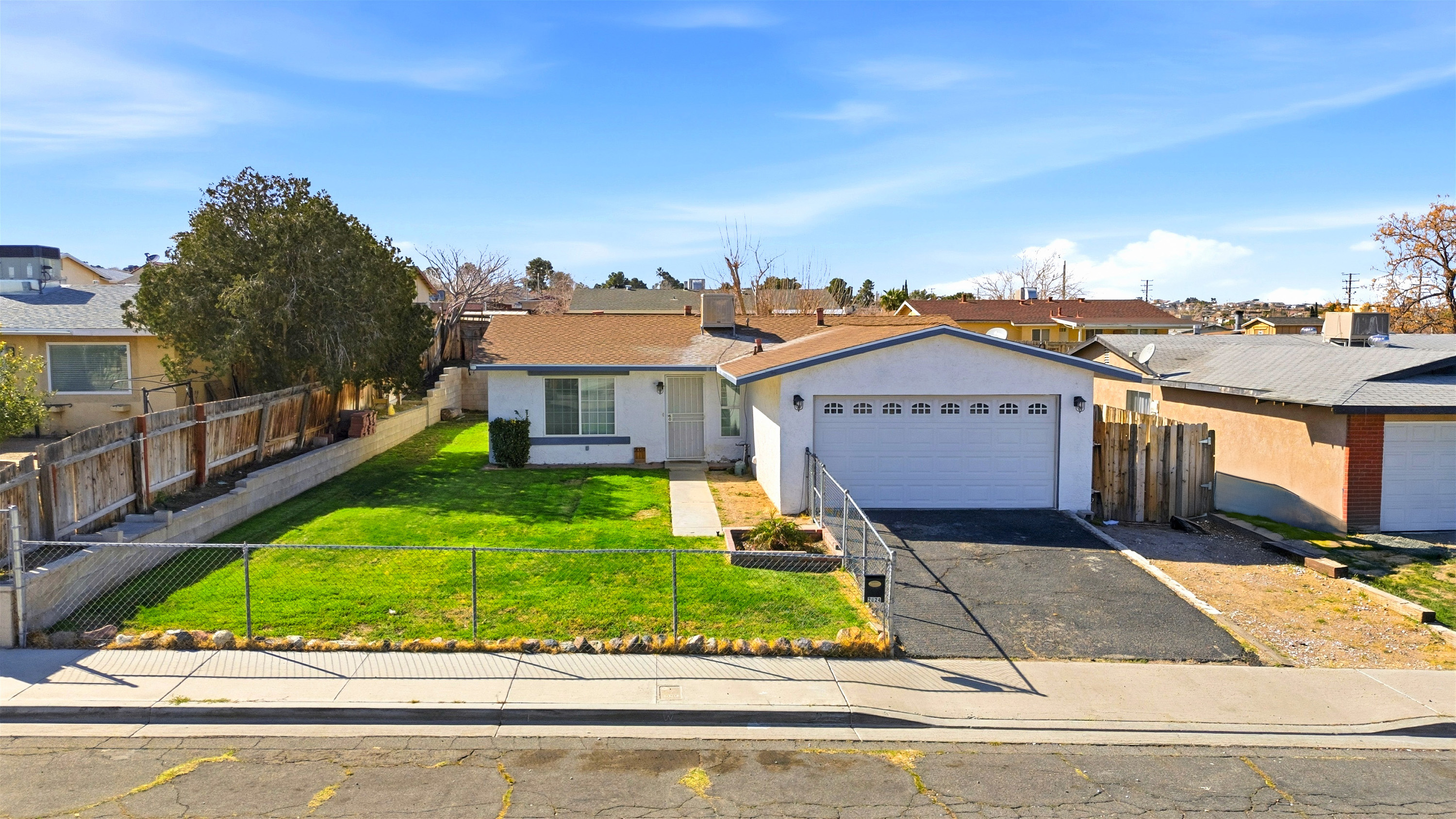 2024 Rushmore Drive, Barstow CA 92311 — refreshed single-story home with fenced yard, 3 bedrooms plus den, 2 baths, 1,040 sq ft, 2-car garage and easy I-15 access