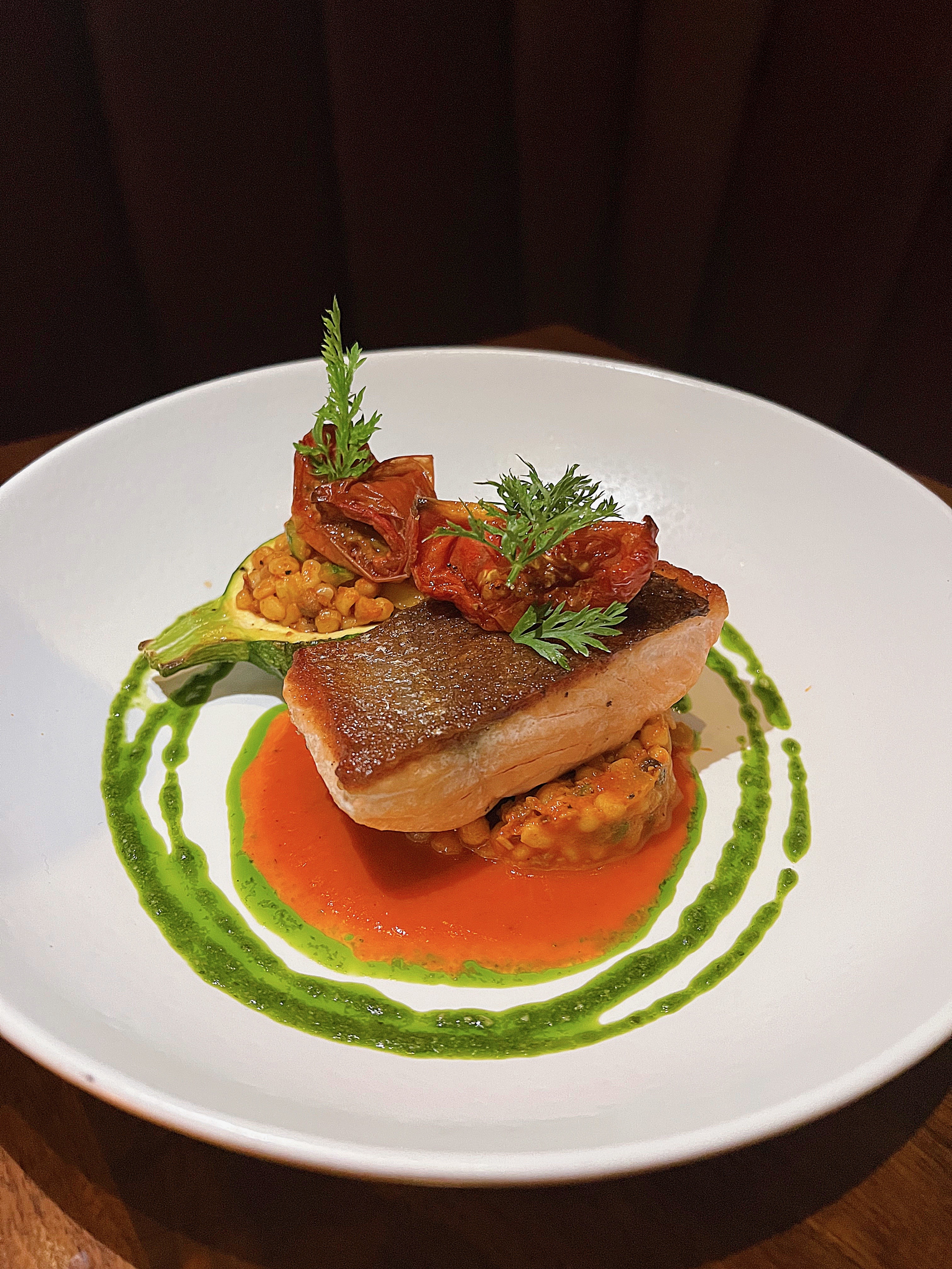 Pan-Seared Sea Bass with Herb Emulsion at Et Voilà French Bistro