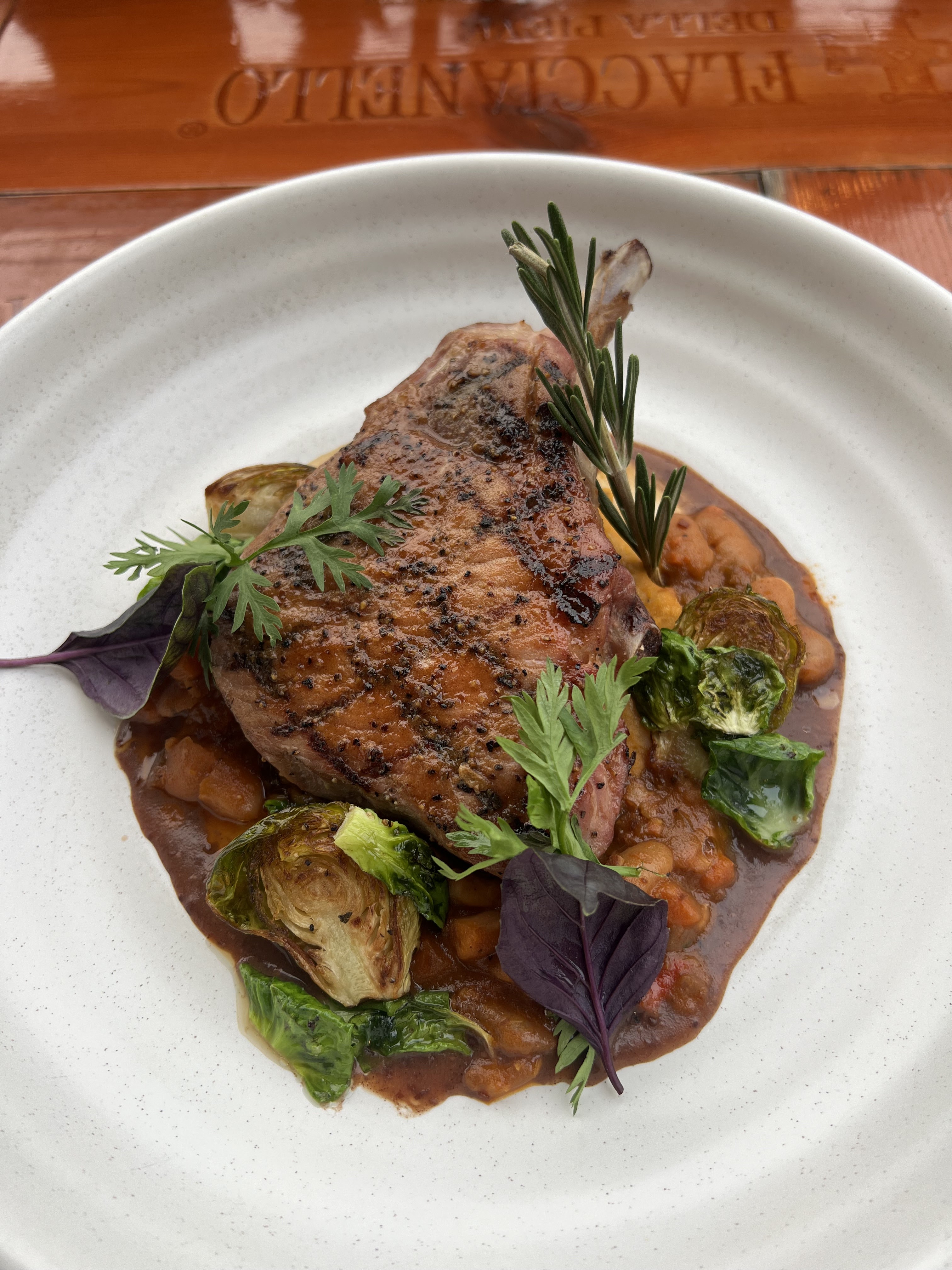 Roasted Pork Chop with Cassoulet Beans at Et Voilà French Bistro