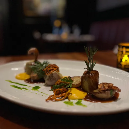 Plated Dish with Green & Orange Sauces at Et Voilà French Bistro