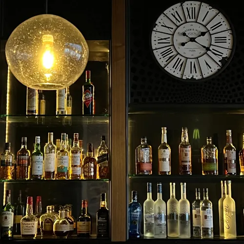 Back-Bar Shelves & Spirits Clock at Et Voilà French Bistro