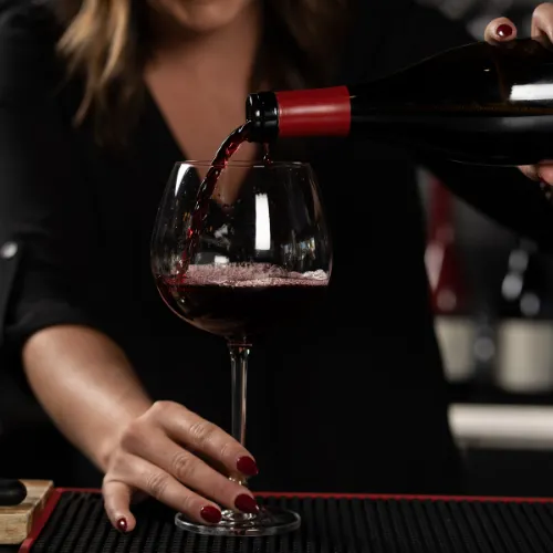 Pouring Red Wine at the Table at Et Voilà French Bistro