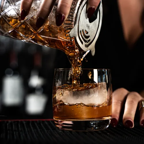 Pouring a Drink Behind the Bar at Et Voilà French Bistro