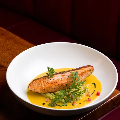 Salmon in a Bowl with Sauce & Garnish at Et Voilà French Bistro