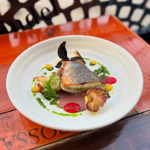 Plated Dish with Herb Sauce & Peppers at Et Voilà French Bistro