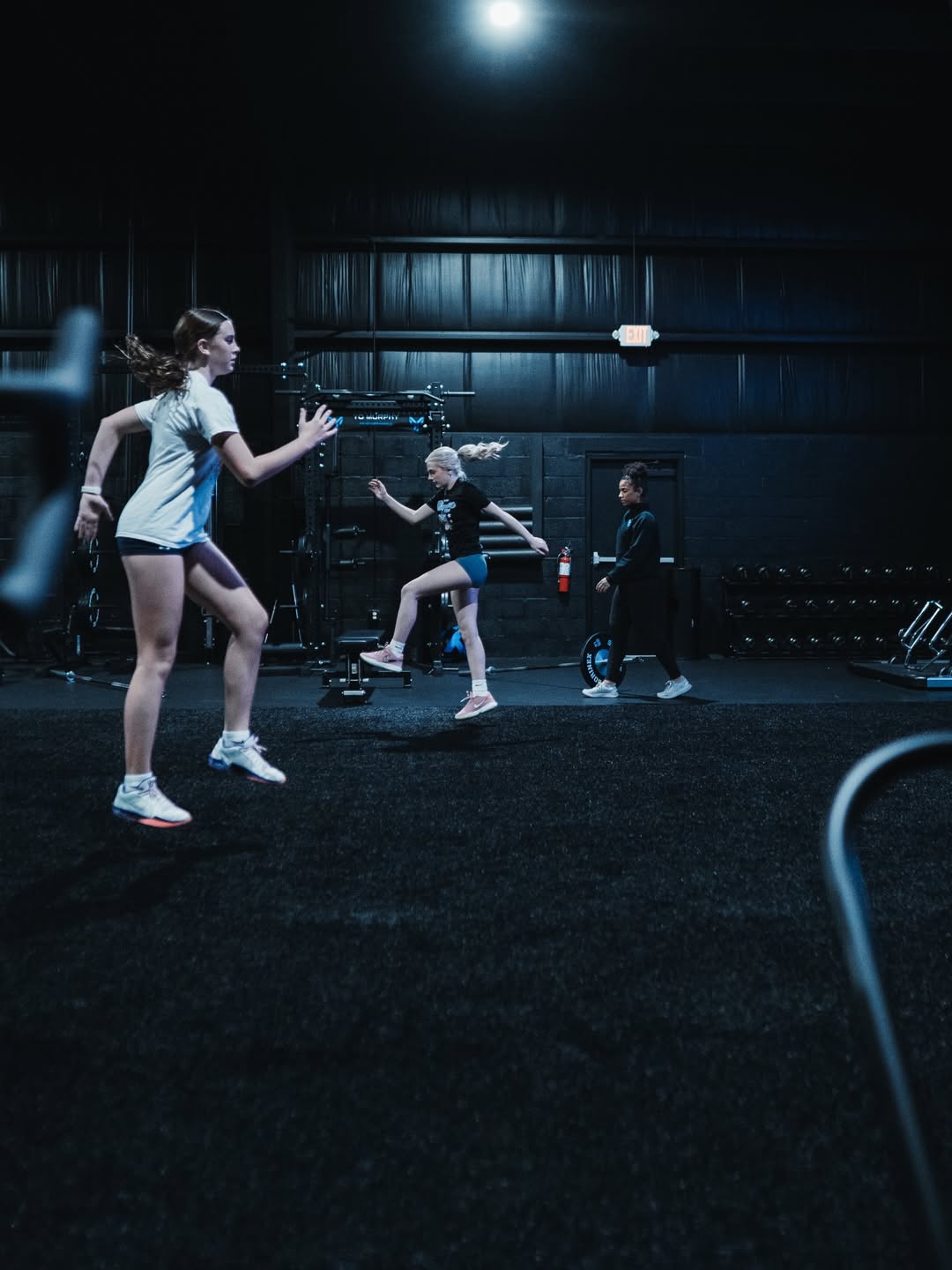 Female athletes training on plyometric boxes