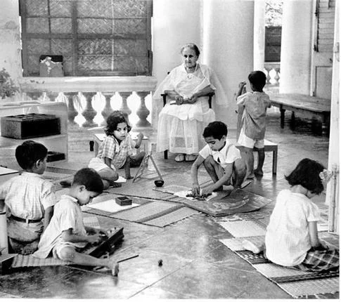 Maria Montessori observing children in India