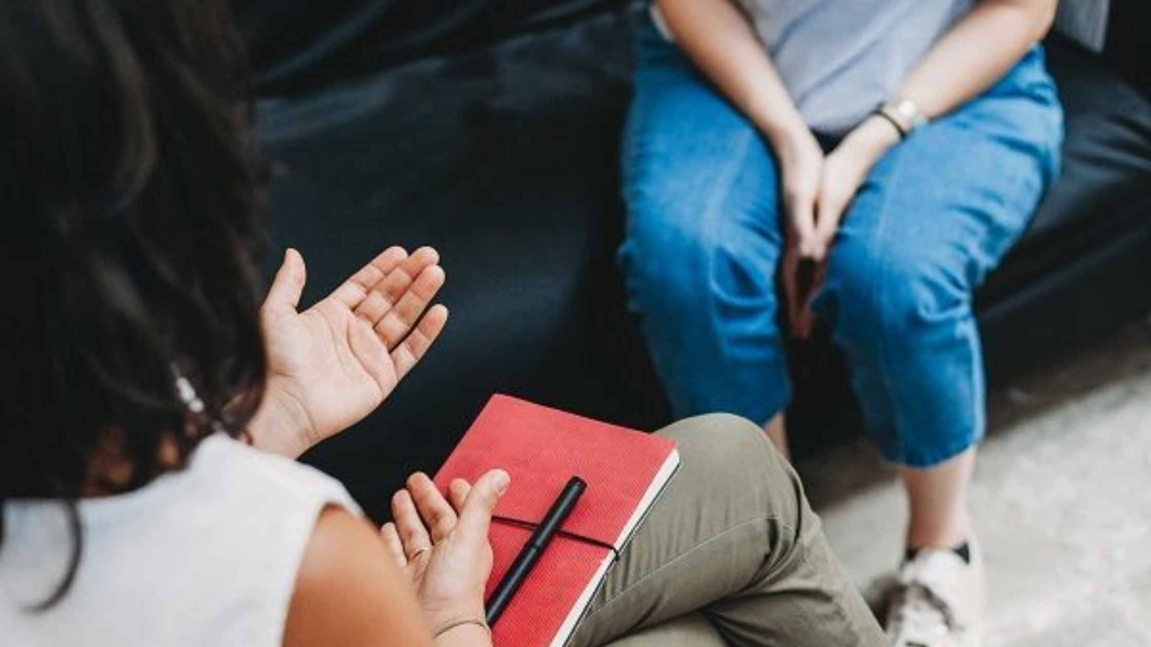 Person holding journal in support group setting, representing protection strategies, documenting narcissistic abuse, setting boundaries, and seeking help to protect yourself from manipulation