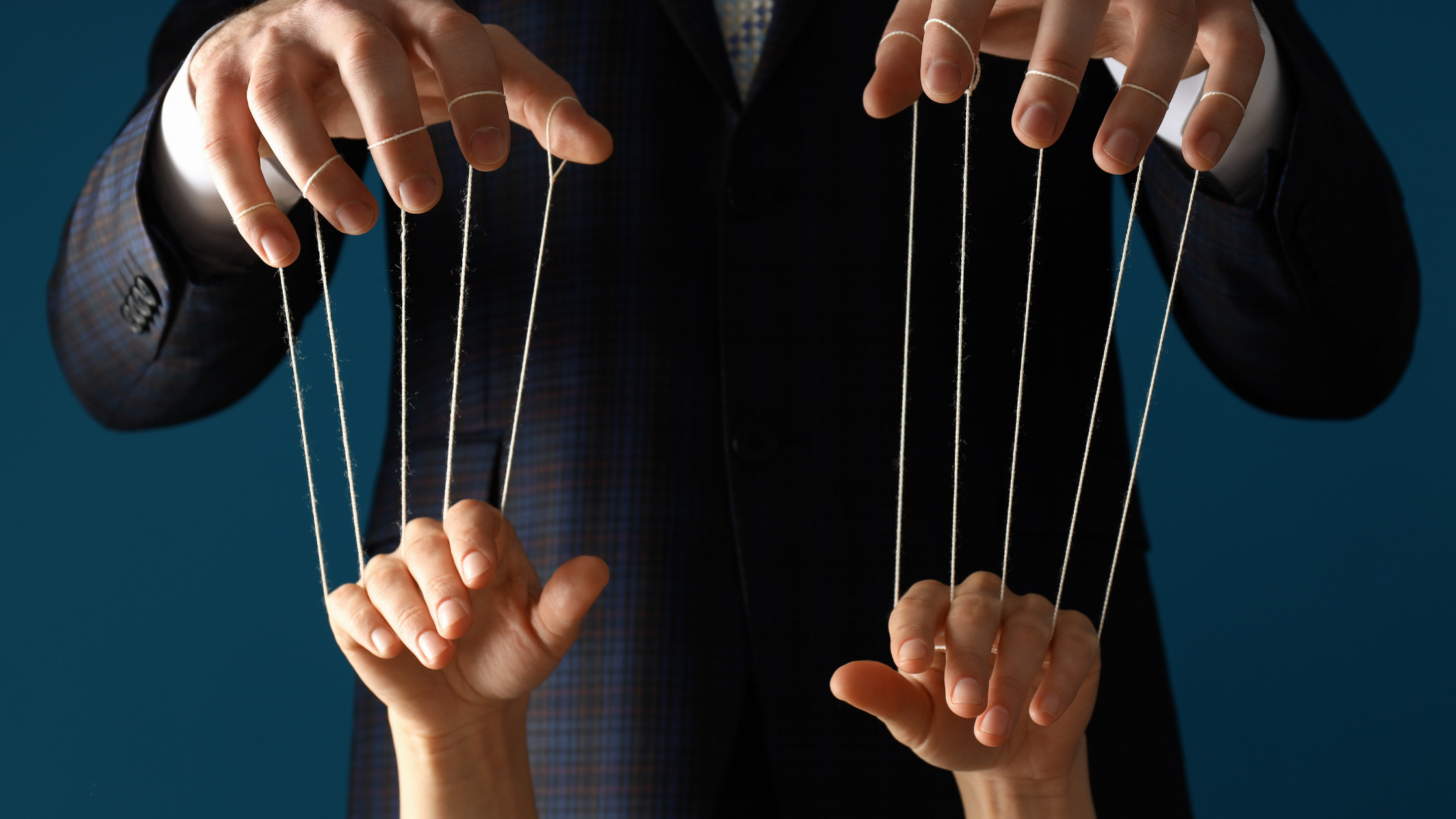 Hands controlling multiple puppet strings representing narcissistic control of multiple people, flying monkeys, extended manipulation network, and how narcissists manipulate their support system Hands controlling multiple puppet strings representing narcissistic control of multiple people, flying monkeys, extended manipulation network, and how narcissists manipulate their support system