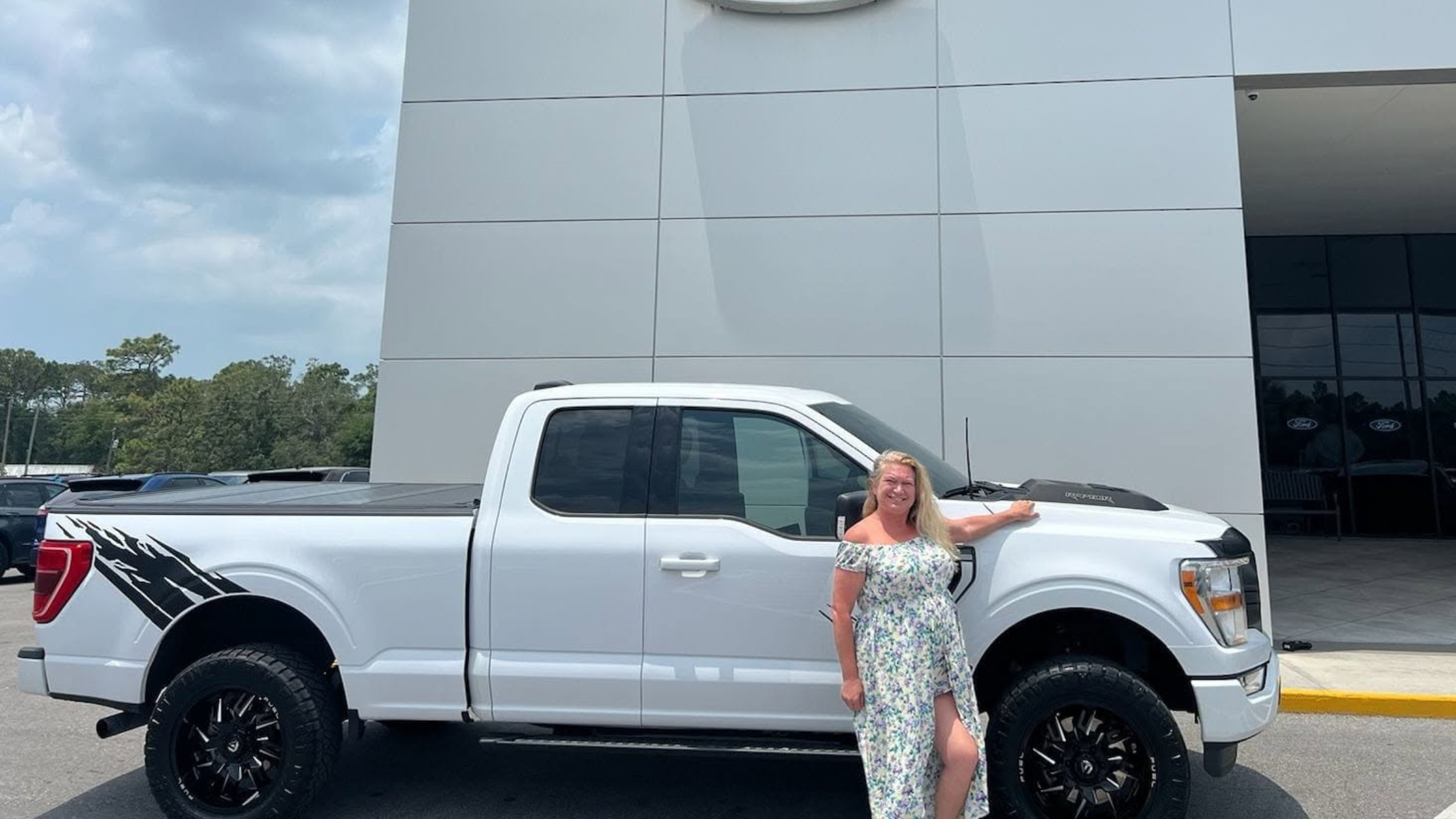 Woman standing confidently with new white truck at dealership, representing reclaiming independence, making personal decisions, and choosing yourself over narcissist approval Woman standing confidently with new white truck at dealership, representing reclaiming independence, making personal decisions, and choosing yourself over narcissist approval