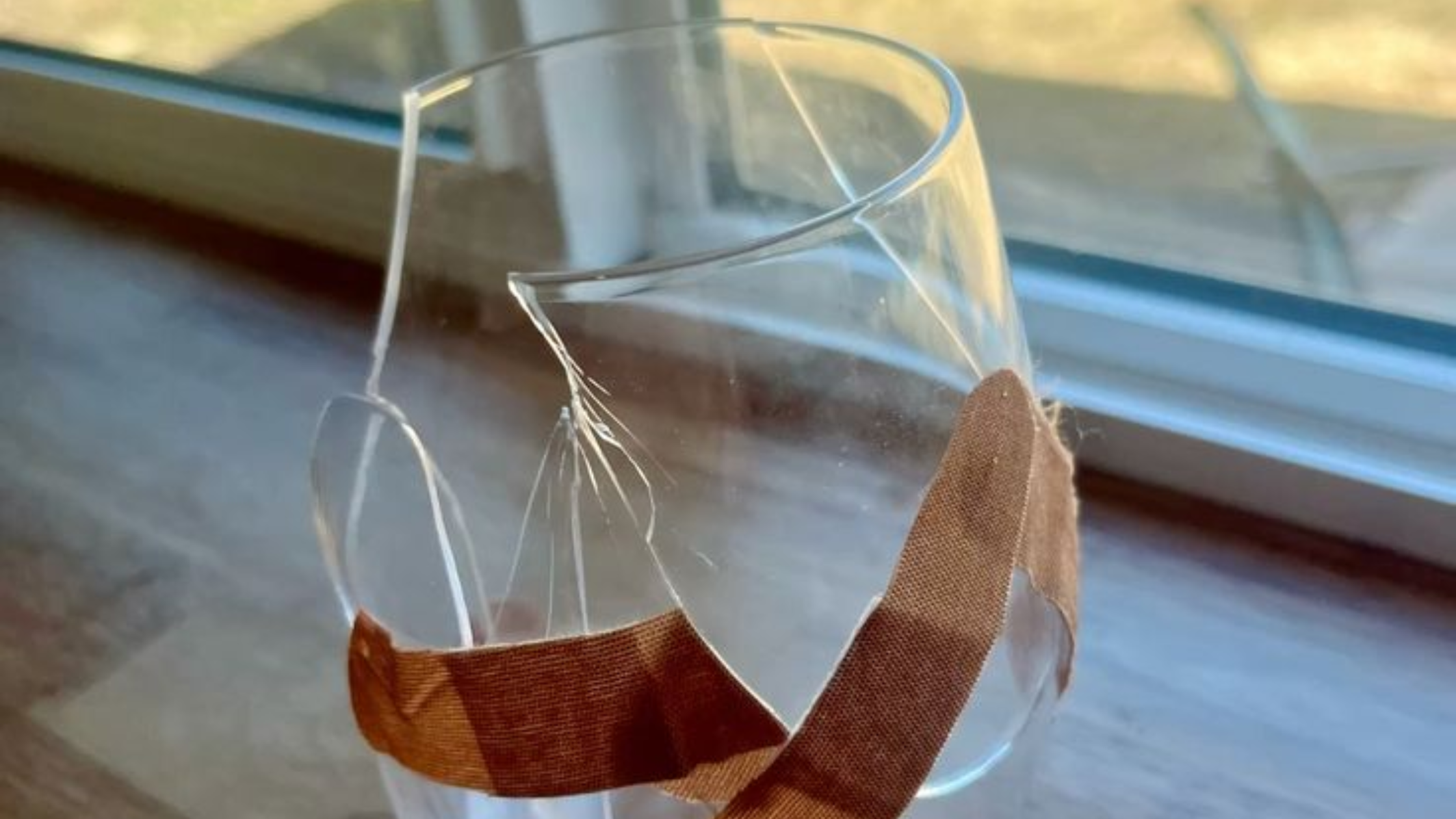 Broken glass held together with cloth tape, representing shattered trust after narcissistic silent treatment, relationship damage, fragile recovery, and the emotional aftermath of being ignored Broken glass held together with cloth tape, representing shattered trust after narcissistic silent treatment, relationship damage, fragile recovery, and the emotional aftermath of being ignored