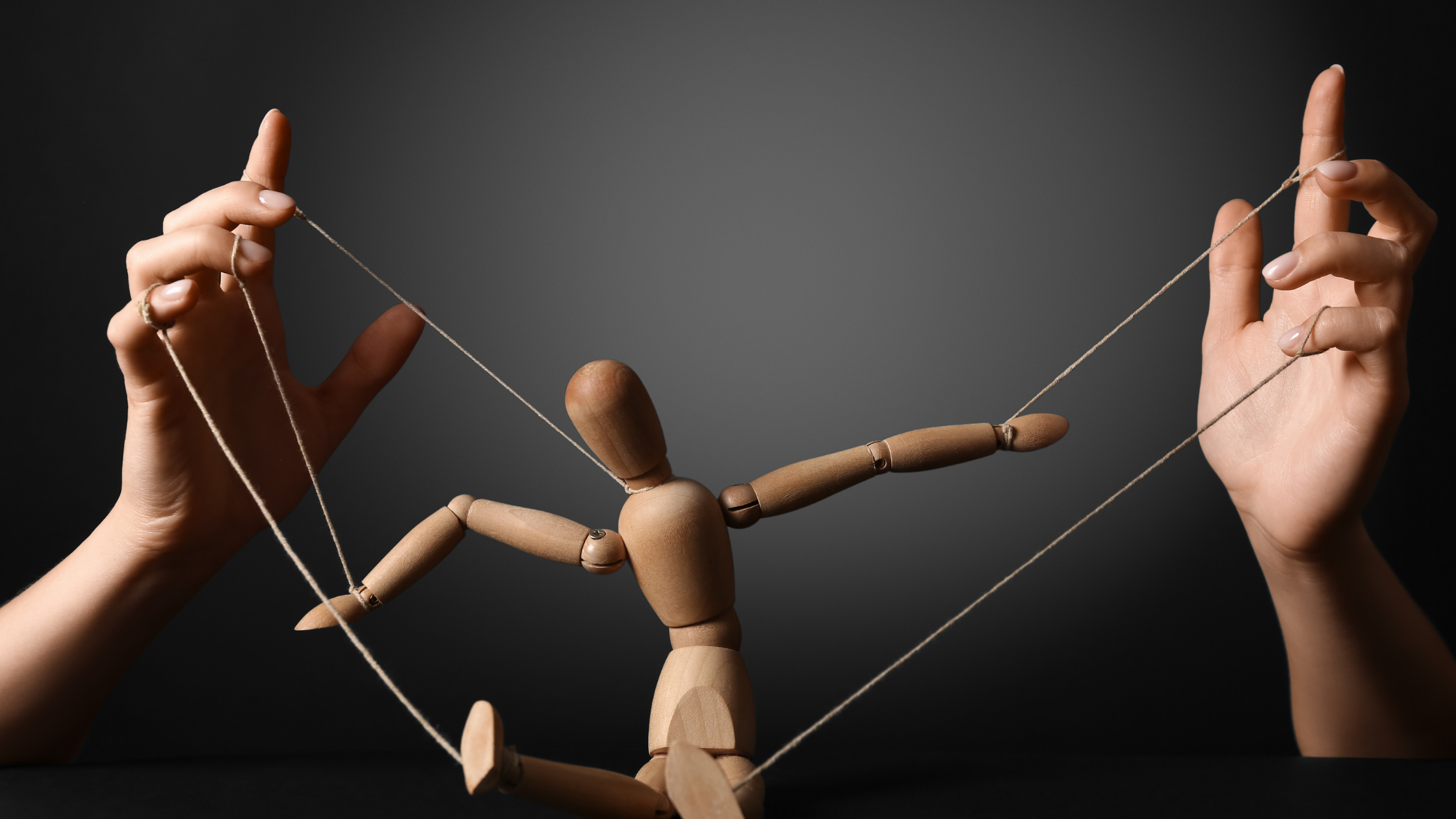 "Wooden puppet controlled by strings from two hands, representing shared narcissistic control, multiple manipulators, co-parenting narcissists, and how narcissists coordinate with enablers to control victims