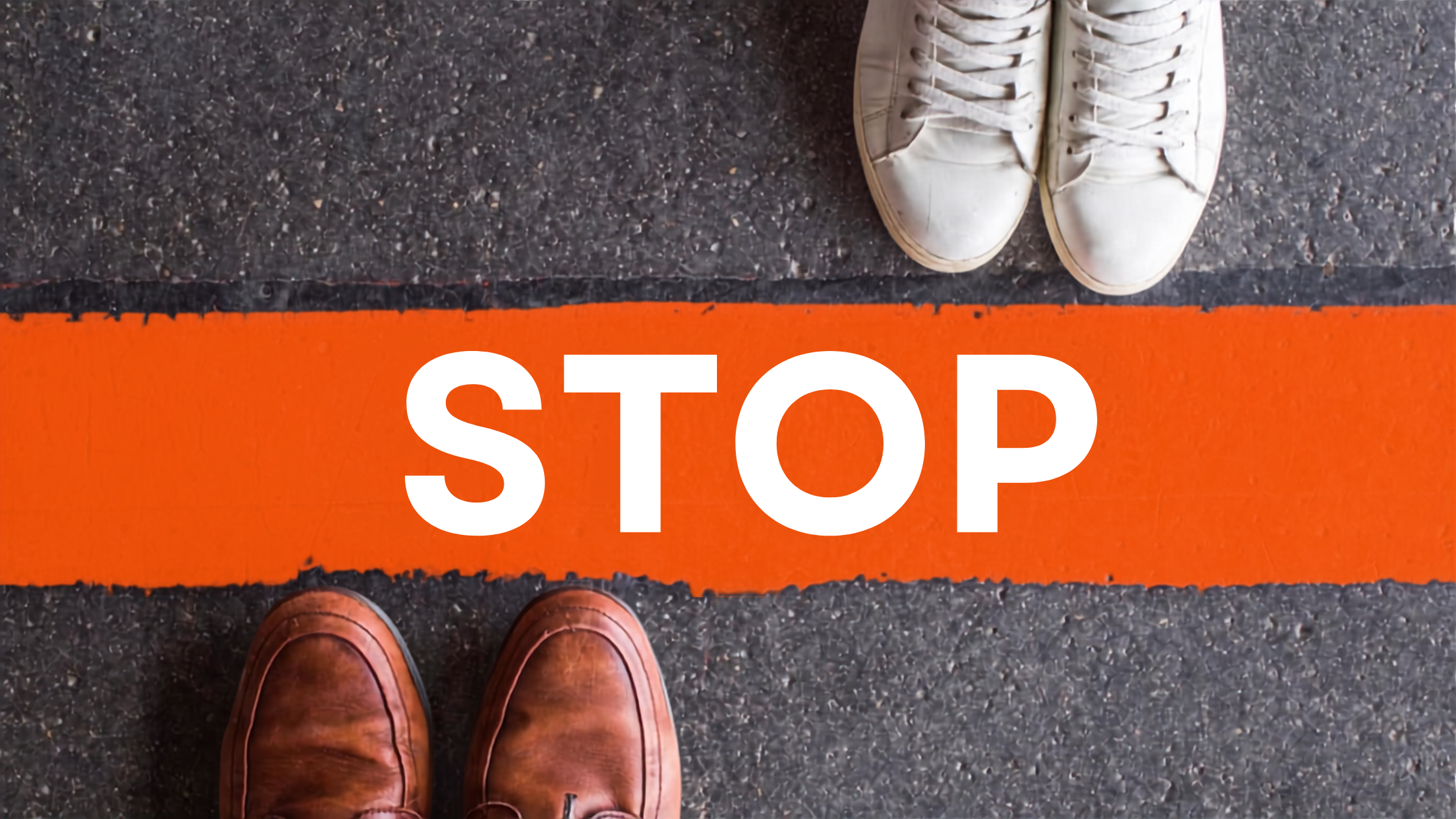 Feet on either side of orange stop line, representing setting firm boundaries, walking away from narcissist, no contact decision, and the clear line you won't cross with a narcissist