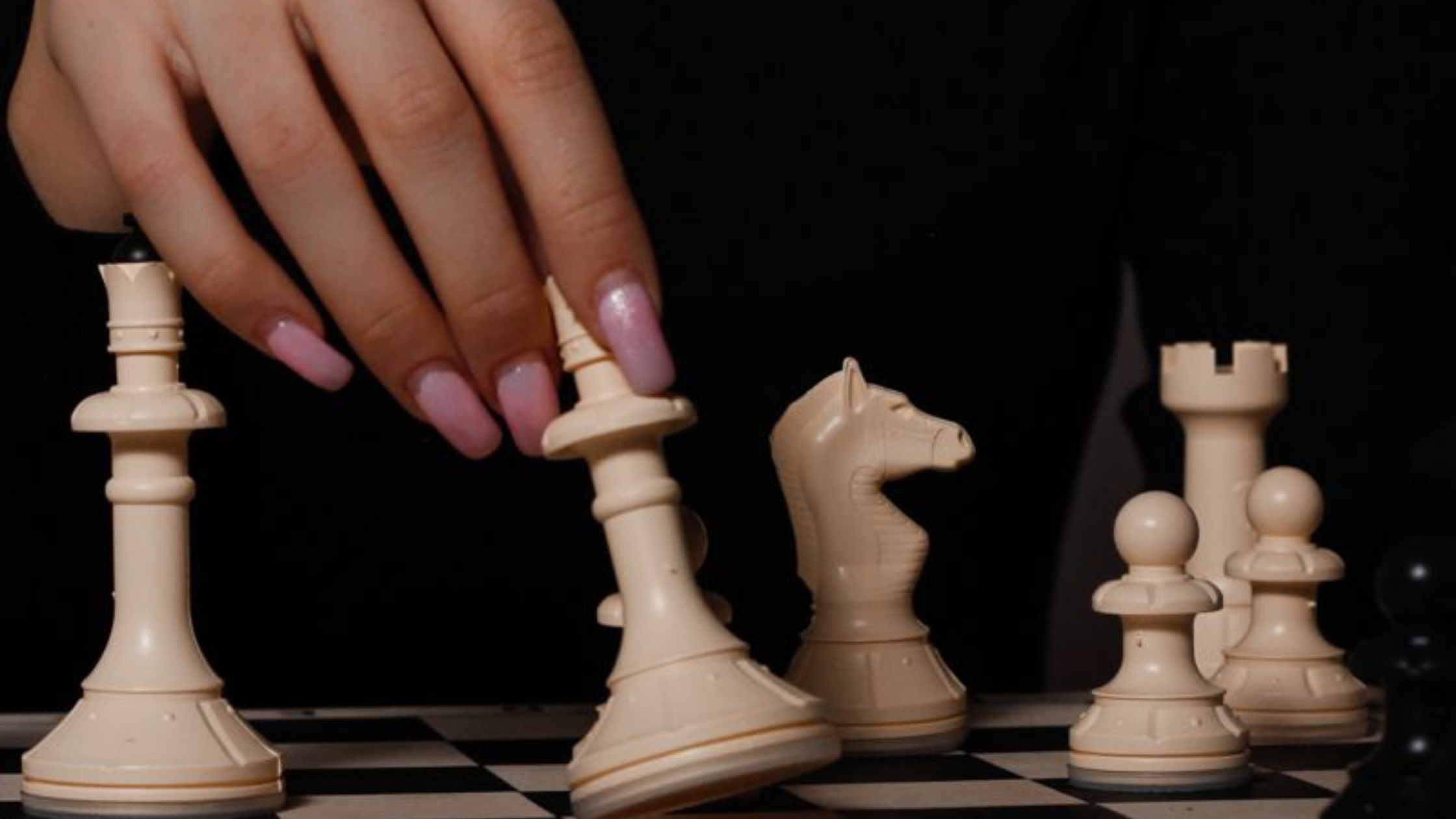 "Hand moving chess pieces strategically on chessboard, representing tactical responses to gaslighters, strategic phrases to disarm manipulators, and outsmart narcissistic manipulation tactics