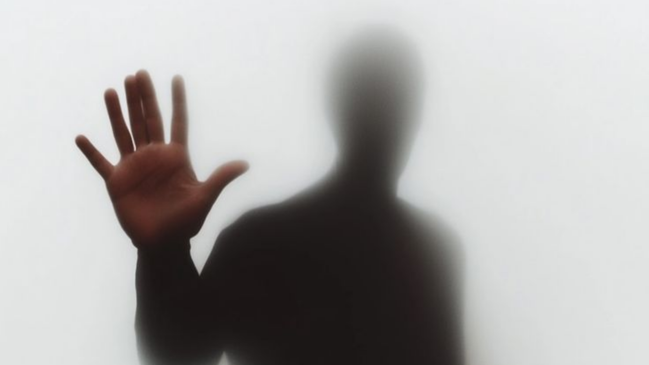 Hand raised in firm stop gesture with blurred figure behind, representing shutting down narcissists, powerful defensive responses, standing firm against manipulation, and silencing manipulative tactics through strong boundaries Hand raised in firm stop gesture with blurred figure behind, representing shutting down narcissists, powerful defensive responses, standing firm against manipulation, and silencing manipulative tactics through strong boundaries