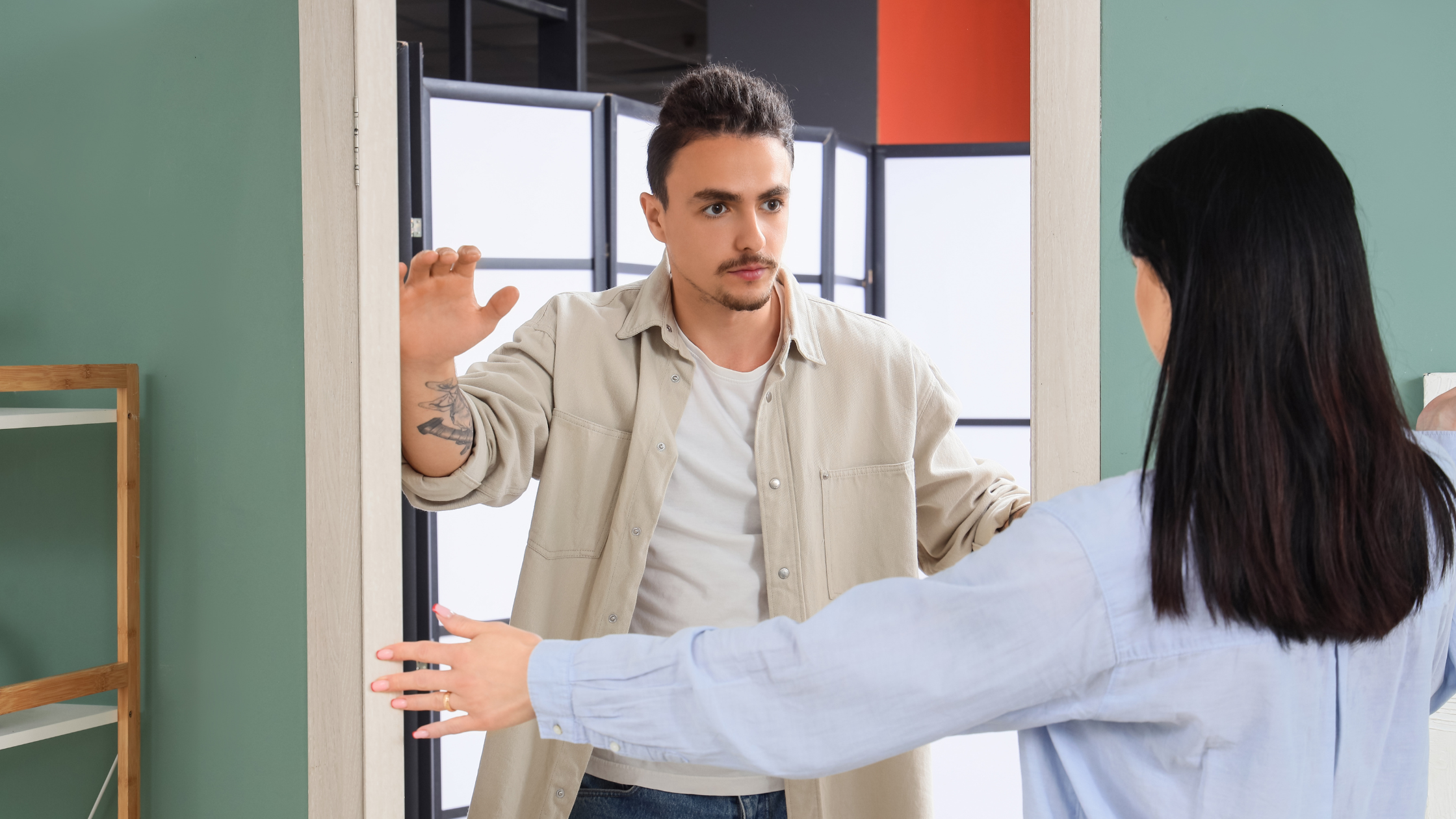 Man dismissing and blocking woman's attempt to communicate at doorway, representing narcissistic resistance to dialogue, communication barriers, rejection of connection, and the challenge of talking to narcissists Man dismissing and blocking woman's attempt to communicate at doorway, representing narcissistic resistance to dialogue, communication barriers, rejection of connection, and the challenge of talking to narcissists