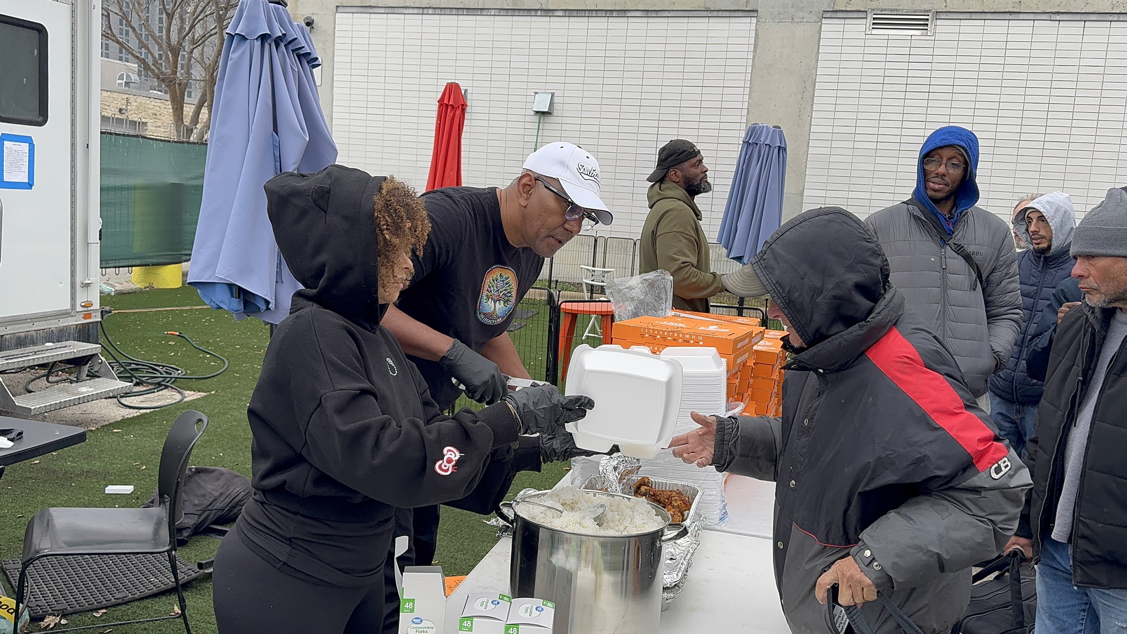 Volunteers serving hot meals to community members