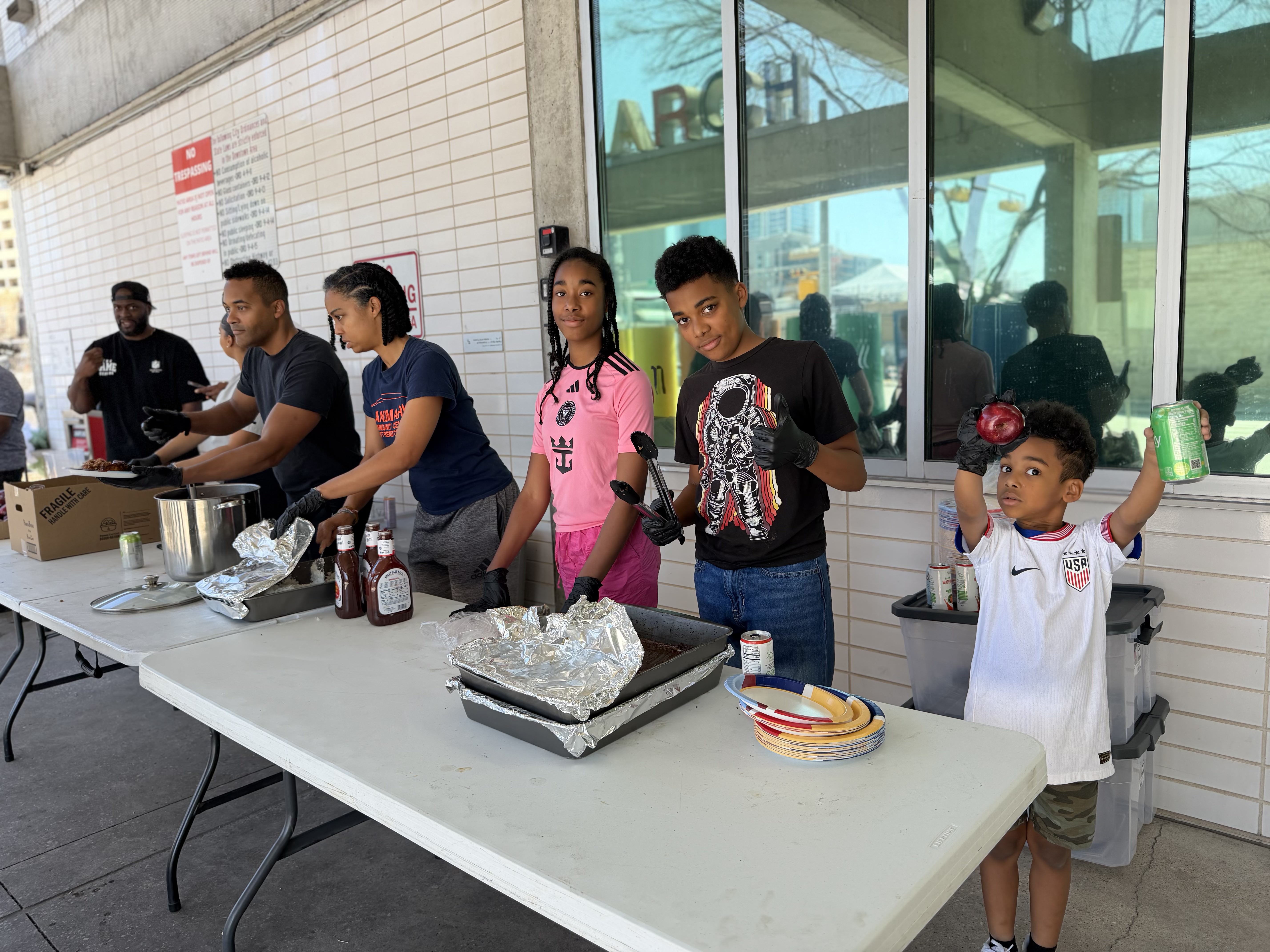 Young volunteers helping serve meals