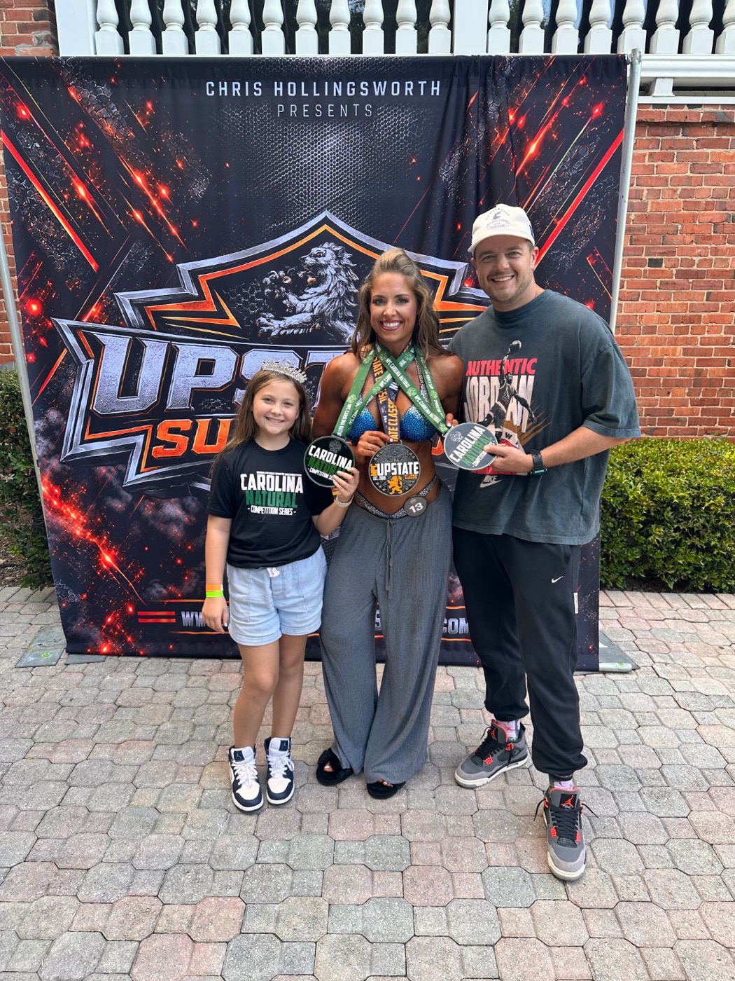 Cam Brown with her family and her NPC Upstate Natural and Upstate Classic medals