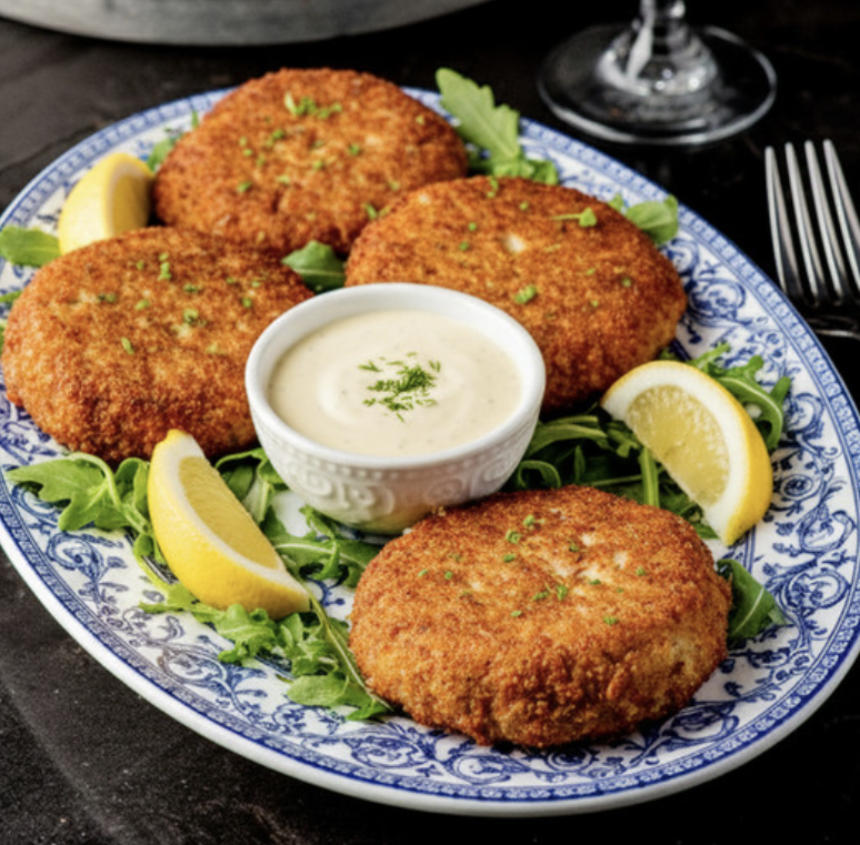 Baked crab stacks with lemon wedges and dipping sauce, 21 grams of protein per portion