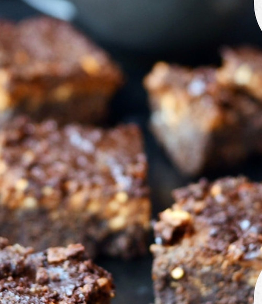 PB banana chocolate protein brownies stacked on a plate, 11g protein per square