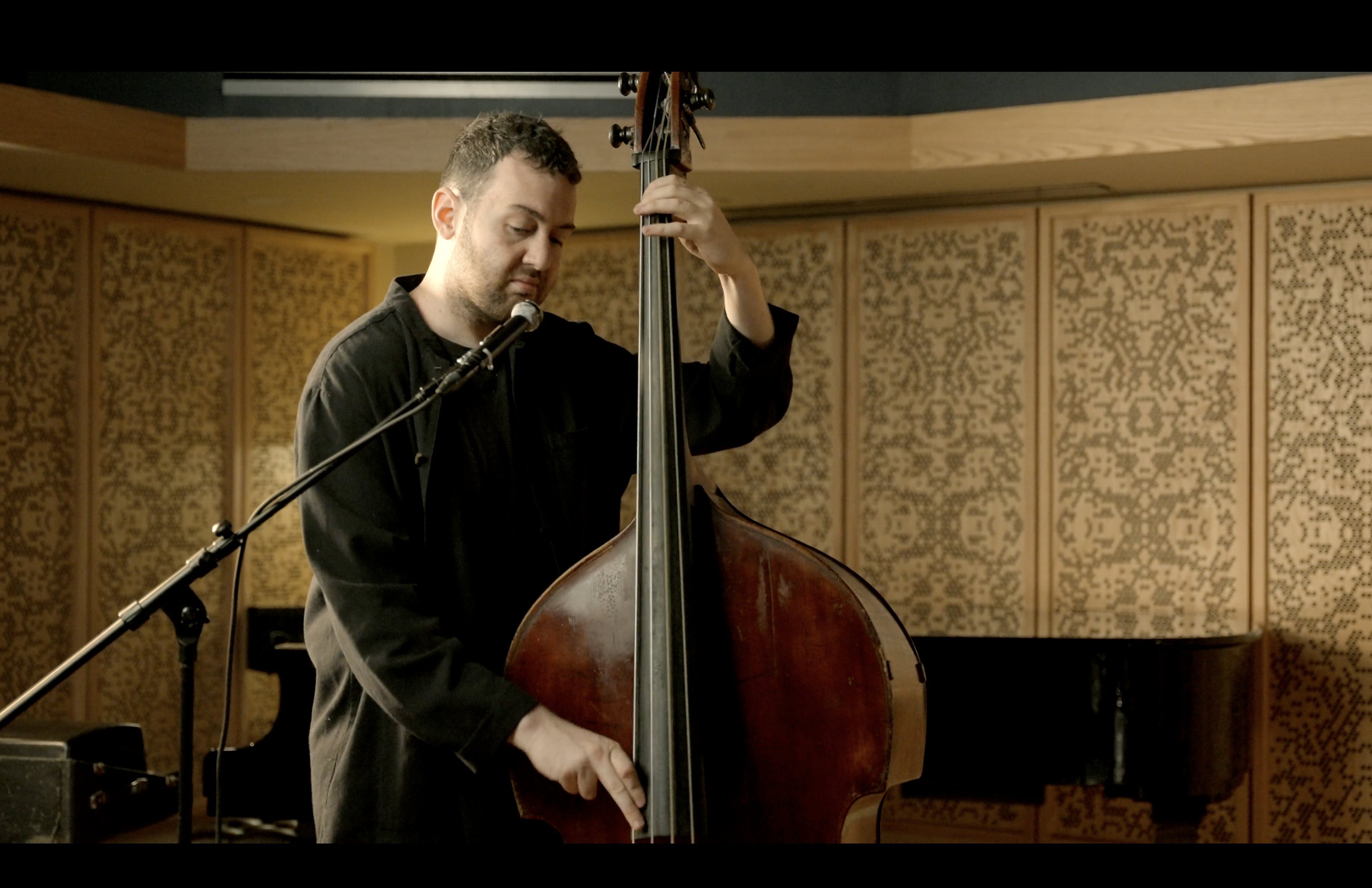 Cole Davis playing upright bass in the studio