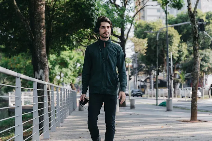 A person walking outdoors on a calm street