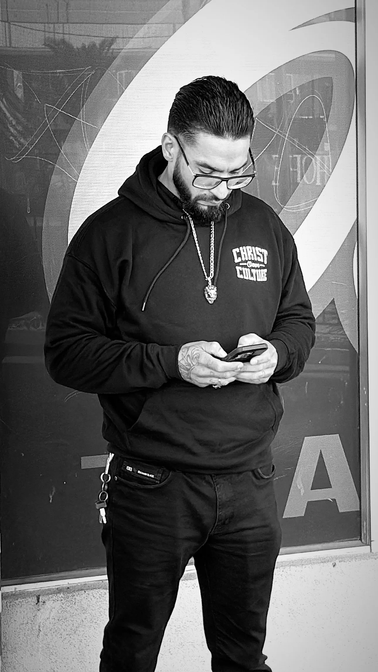 Model wearing the Christ Over Culture hoodie from behind, black and white
