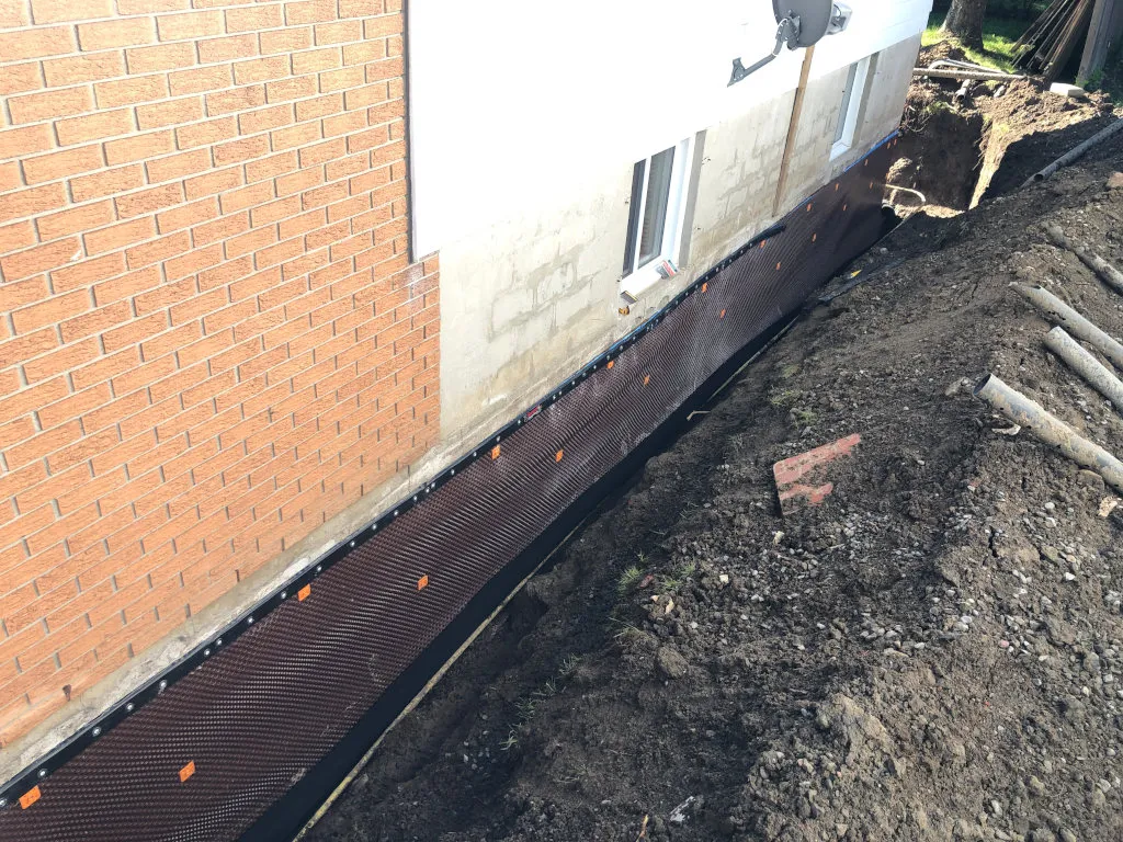 Exterior foundation waterproofing membrane application