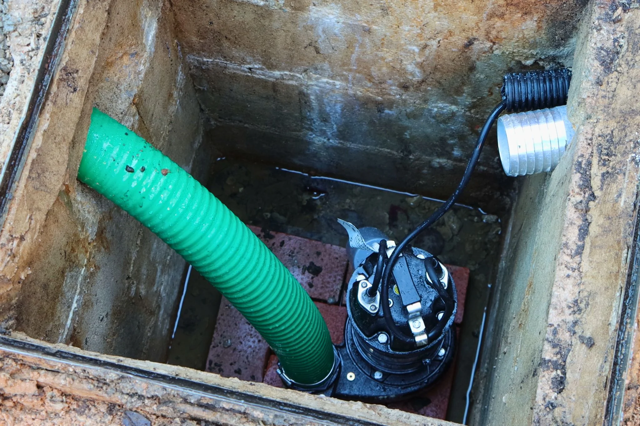 Sump pump pit installation in basement