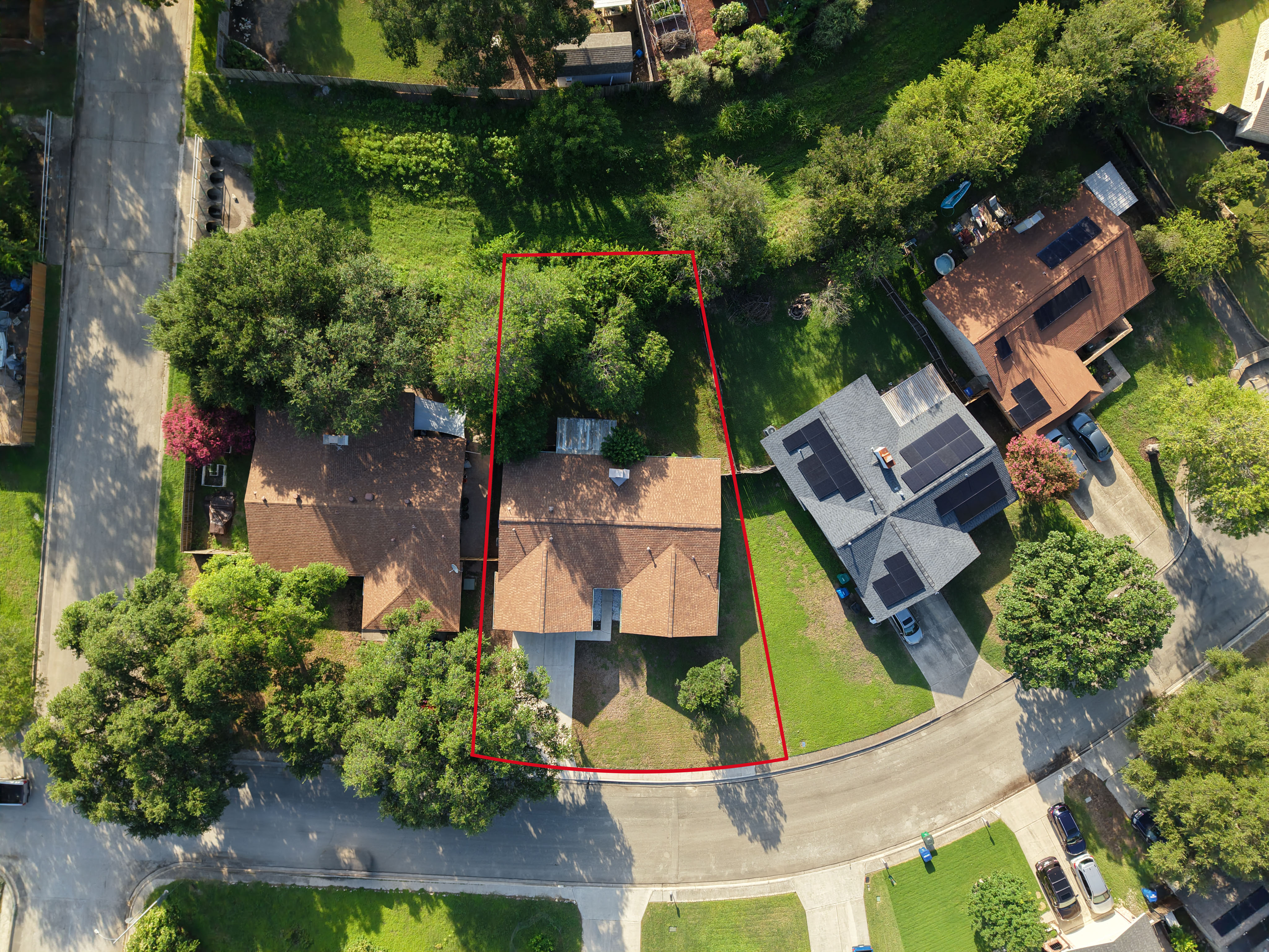 Wide drone view showing a residential property and surroundings