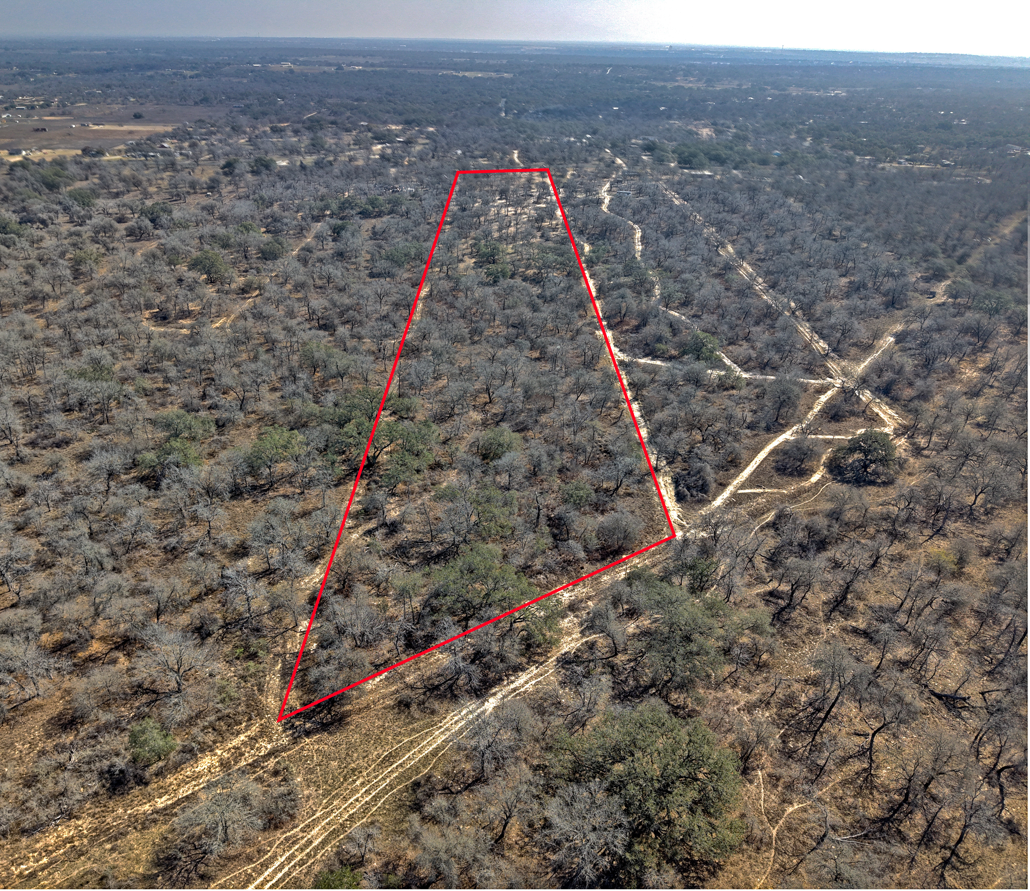 Closer drone view of a lot or land property