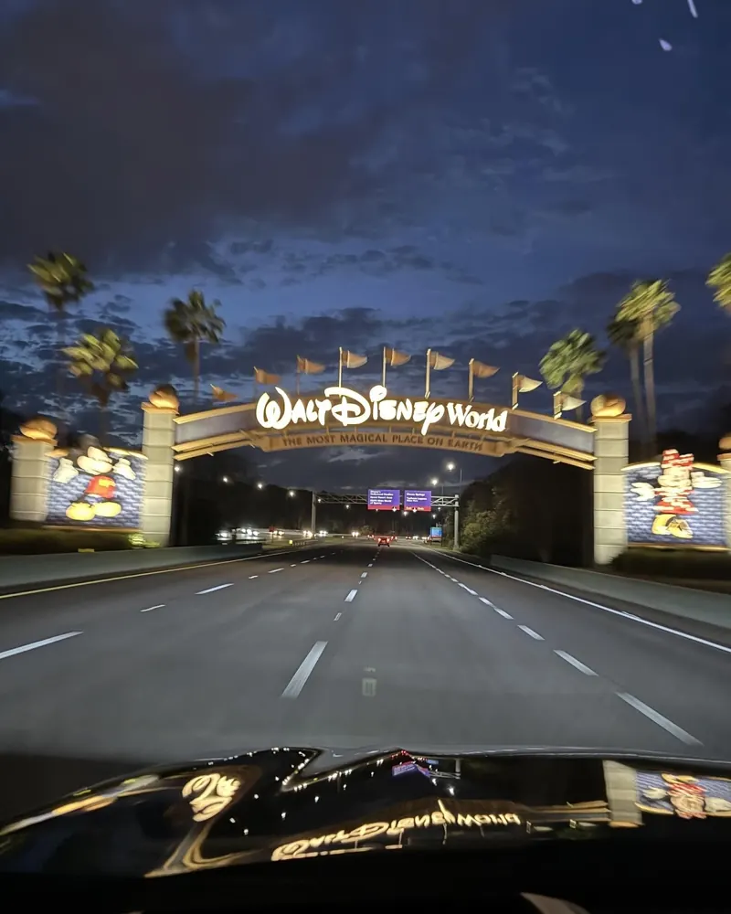 Night drive toward the Walt Disney World entrance sign