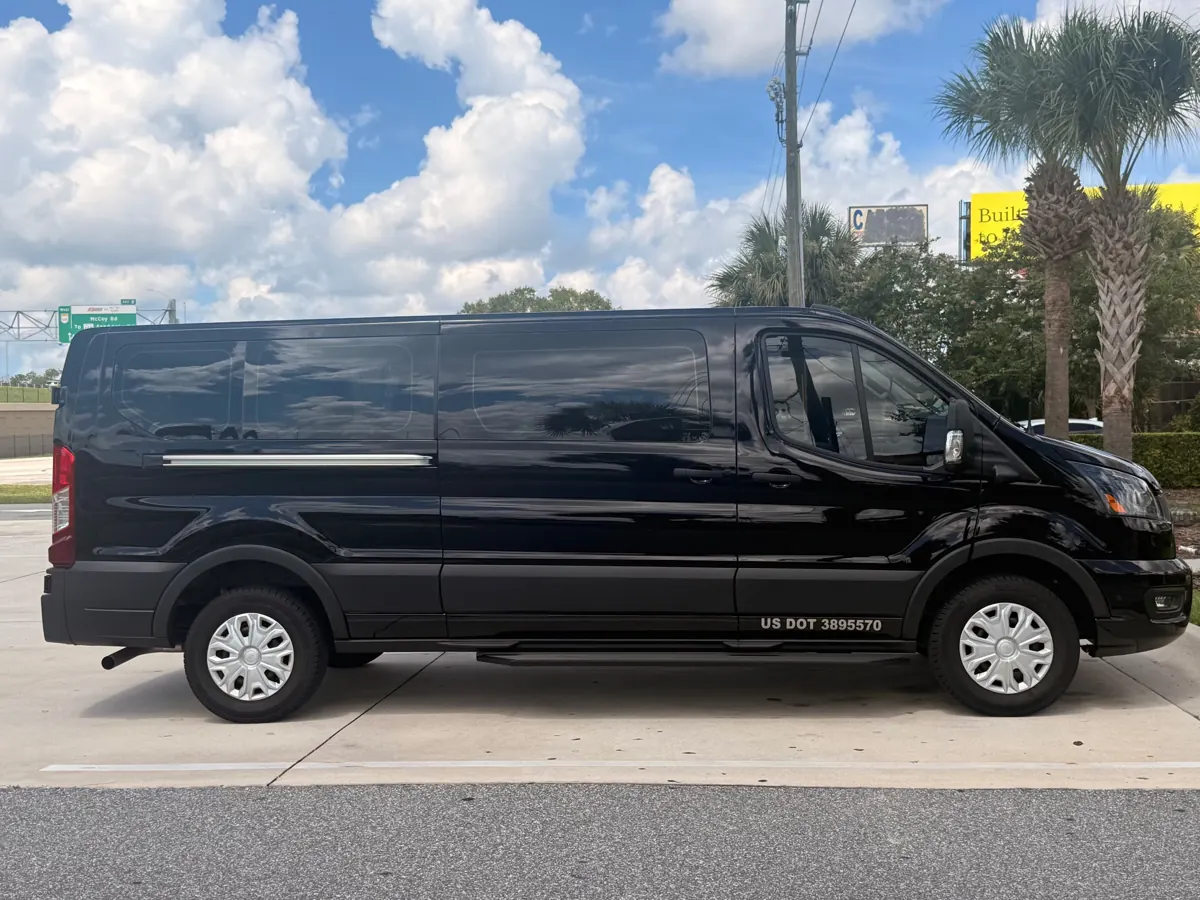 Black Ford Transit passenger van, side view